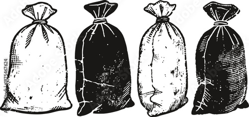 Four vintage burlap sacks, two white and two black, standing upright and tightly closed