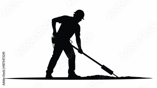 Construction worker using jackhammer on pavement