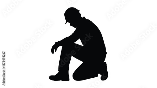 Man in silhouette kneeling in contemplation