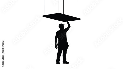 Silhouette of construction worker holding suspended platform