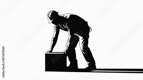 Man lifting heavy box with effort and concentration