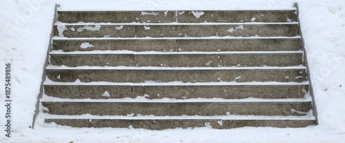 The steps of the stone staircase cleared of snow