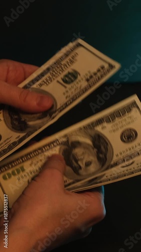 Vertical video. Hands are counting hundred dollar bills. Cash money
