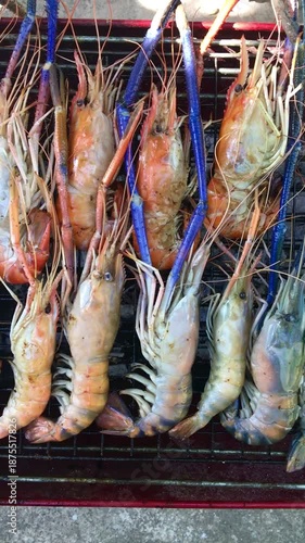 Grilled shrimp, seafood, barbecue, grilled over charcoal, street food style, creating a smoky atmosphere.