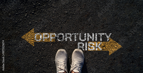Top view of shoes with opportunity and risk directions on asphalt road symbolizing choice selection strategy uncertainty and leadership mindset for career or investment business decisions concept.
