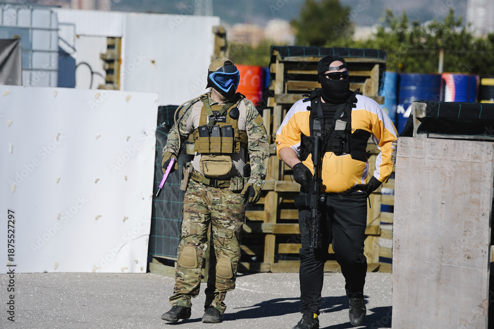 Fototapeta premium Airsoft players walking with gear on a field
