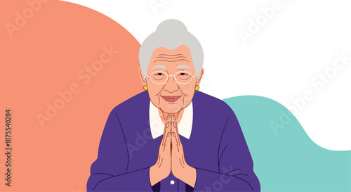 Portrait of a kind and smiling elderly Asian woman with her hands together in a traditional greeting or gesture of gratitude.