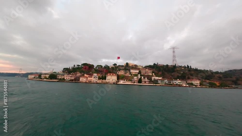 Turkish flag waving on the stern of a passenger ferry crossing the Bosphorus, The rear of the yacht while cruising at sea. The atmosphere evokes adventure and freedom at sea.