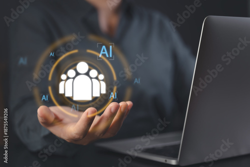 Hand holding a digital human icon surrounded by AI symbols. Concept of artificial intelligence in human resources, talent acquisition, and smart workforce management in the modern era