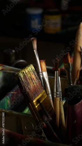 Artist Studio Workspace with Easel Paint Palette and Various Brushes