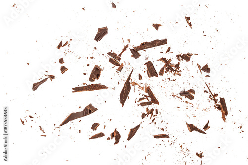 Tableau sur toile Top view of scattered dark chocolate fragments and crumbs isolated on white back