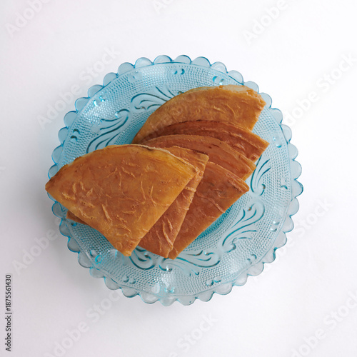 Stacked Kuih Kapit Cookies on Vintage Blue Glass Plate, Top View