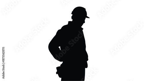 Silhouette of a construction worker in a hard hat standing confidently