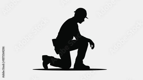 Silhouette of a man kneeling down in a thoughtful pose