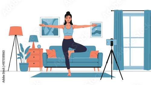 Young woman practicing a yoga tree pose in her living room while recording a video on a smartphone for an online fitness class.