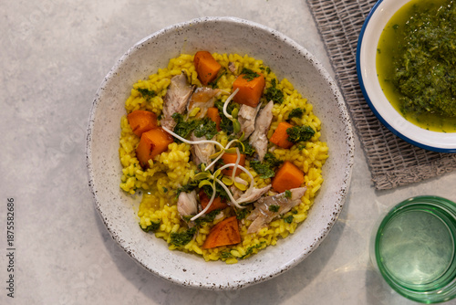 Fish, rice, and carrot dish on a marble floor.