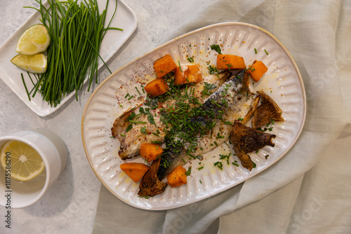 fish served with vegetables, mushrooms, carrots and fresh green onions