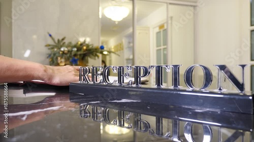 Hotel reception. Female hands at hotel reception for check in, registration and hospitality service. Pen, paper and sign with client at motel for reservation confirmation, travel or accommodation form