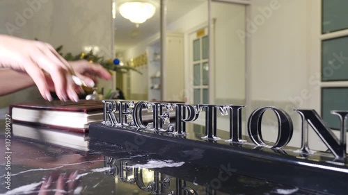 Hotel reception. Female hands at hotel reception for check in, registration and hospitality service. Pen, paper and sign with client at motel for reservation confirmation, travel or accommodation form