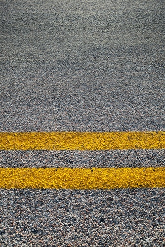 Wallpaper Mural Close-up of double yellow lines painted on an asphalt road, symbolizing rules, safety, and direction. Torontodigital.ca