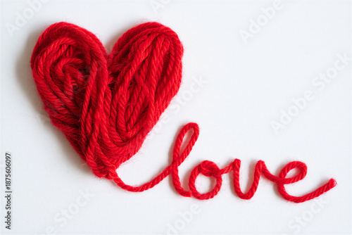 Red yarn heart shape with love word on white background for valentines day or romantic concepts