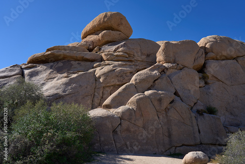 Joshua Tree National Park, CA, USA - October 19, 2025 - Towering granite rock formations under a clear blue desert sky