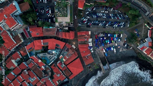Aerial perspective showcases energetic seaside village layout and activity