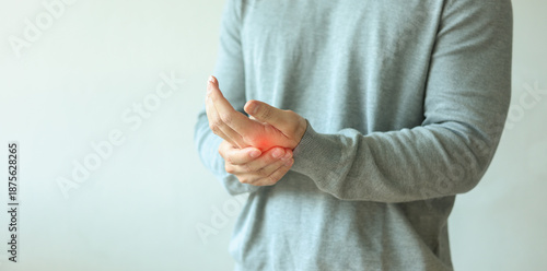 close up adult man massage on his hand and arm for relief pain from hard working on white background at home for stiff or cramp symptom or carpal tunnel syndrome concept