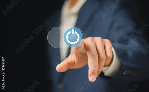 Canvas-taulu businessman pressing power button. Start or shut down concept.