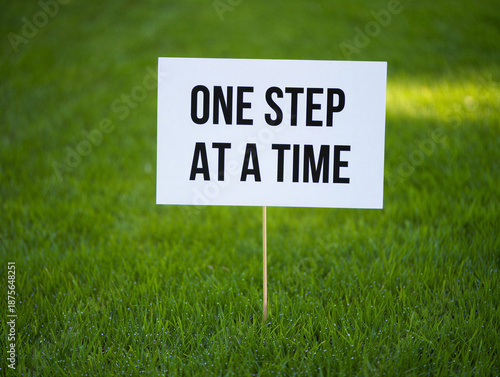 Wallpaper Mural A white yard sign on a wooden stake with a motivational quote on green grass lawn  outdoor inspirational message Torontodigital.ca