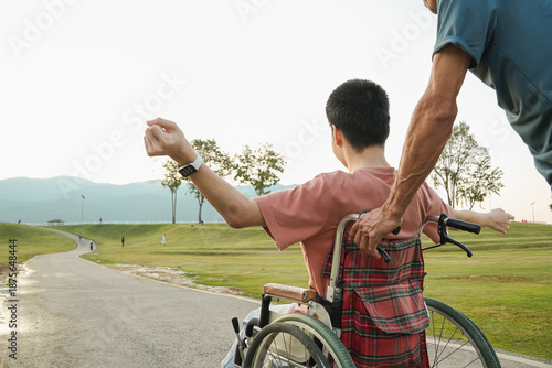 A joyful outdoor lifestyle moment of a young wheelchair user enjoying fresh air in a park with supportive family. Natural light scene expressing freedom, confidence, and inclusive everyday living.
