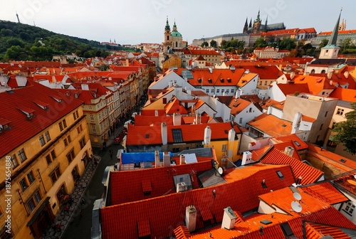 Wallpaper Mural Aerial view of Prague Old Town, capital of Czech Republic & a UNESCO heritage city, with the castle on a hilltop, St. Nicholas Church in Lesser Town & red rooftops of historical houses by a street  Torontodigital.ca