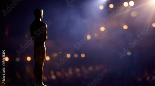 Golden trophy on gala stage. Dramatic spotlight bokeh shows trophy silhouette at academy awards night, trophy symbol of success for film industry ceremony, awards season concept, premium mood