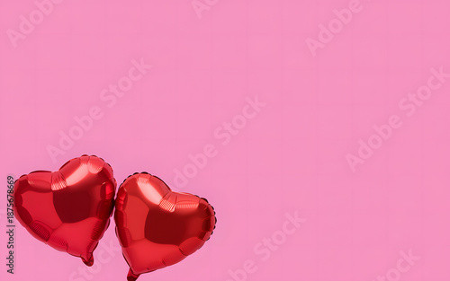 Two red heart-shaped balloons floating on a pink background