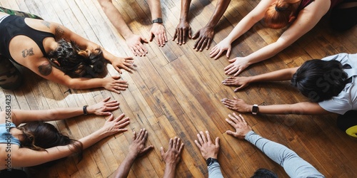 Cuadro en lienzo Diverse group in a circle, hands touching wooden floor