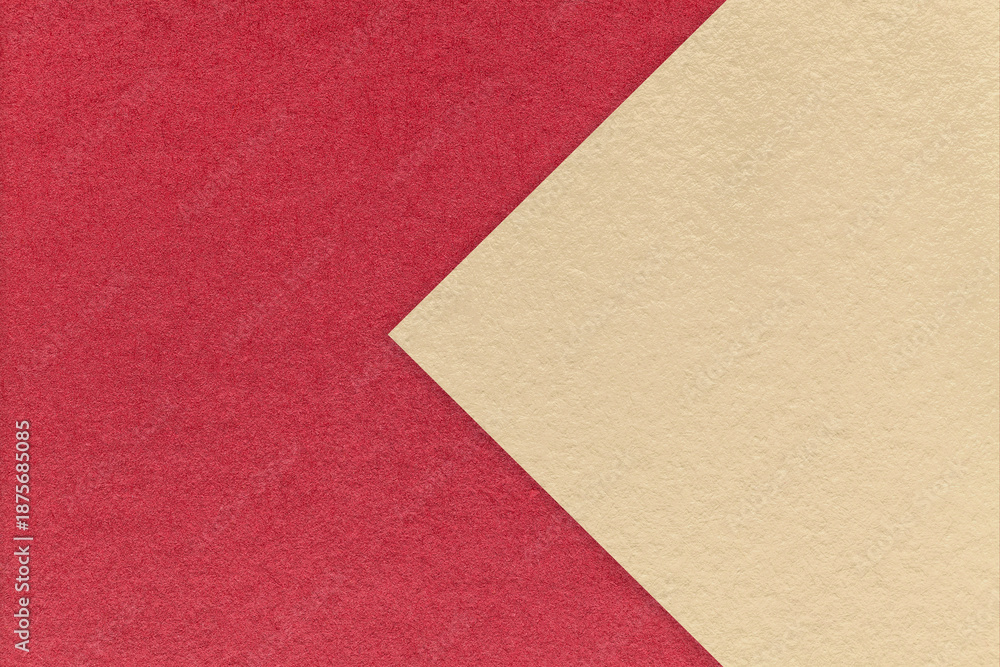 Fototapeta premium Textured red paper background, half two colors with light beige arrow, macro. Template with copy space for banner