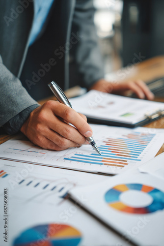 An insurance agent analyzing financial charts while preparing coverage recommendations for a corporate client.