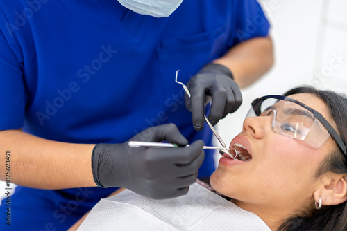 Dentist examining patient during routine dental check up