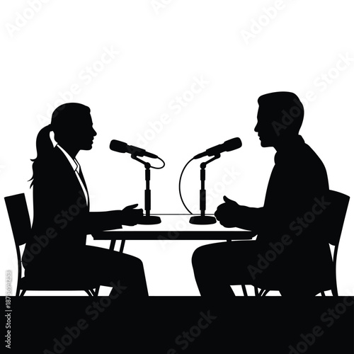 silhouette of two people sitting at a table with microphones