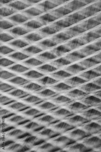 abstract blur motion of metal grid or grate with long time exposure and intentional camera movement to shoot blur in motion creating special effects