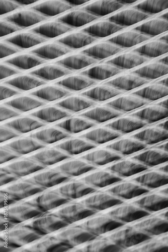 abstract blur motion of metal grid or grate with long time exposure and intentional camera movement to shoot blur in motion creating special effects