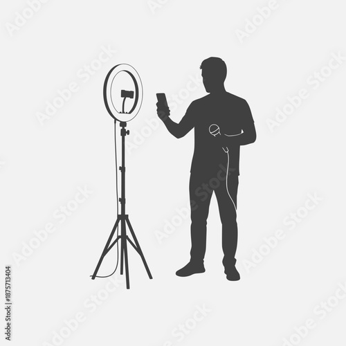 Man using smartphone with ring light on tripod for photography or videography