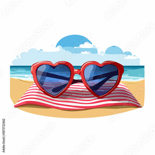 A pair of heart-shaped sunglasses rests on a sandy beach towel, hinting at a romantic getaway.