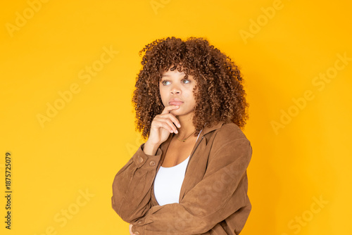 Obraz na plátně young latina woman with a thoughtful expression isolated on white background