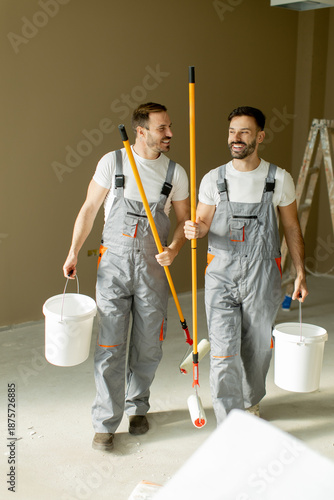 Two painters carrying tools...