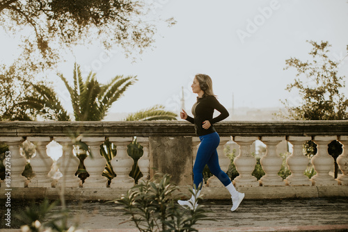 Woman runs along a path in ...