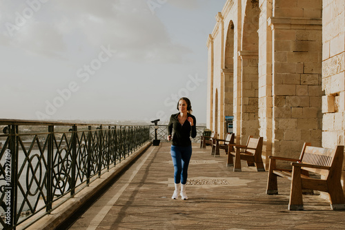 Woman jogging by the waterf...