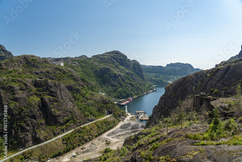 Wallpaper Mural View of emerald waters reflecting the sky between craggy cliffs, a ship docks below, a road winding through the valley, Jossingfjord, Rogaland, Norway. Torontodigital.ca
