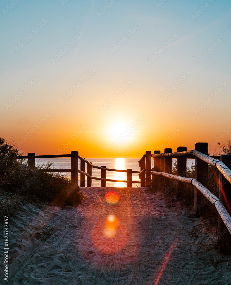 Fototapeta premium Sunset over the Baltic Sea seen from a wooden boardwalk in Latvia