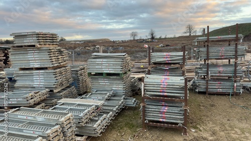 Construction scaffolding and pipes stacked outdoors